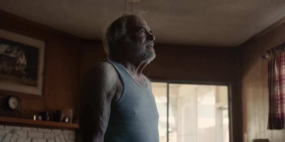 Elderly man with white beard stretching his arms with an elastic band pulling up