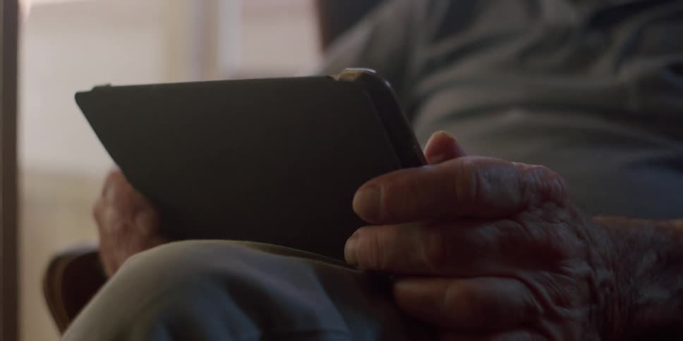 A man is holding a tablet computer