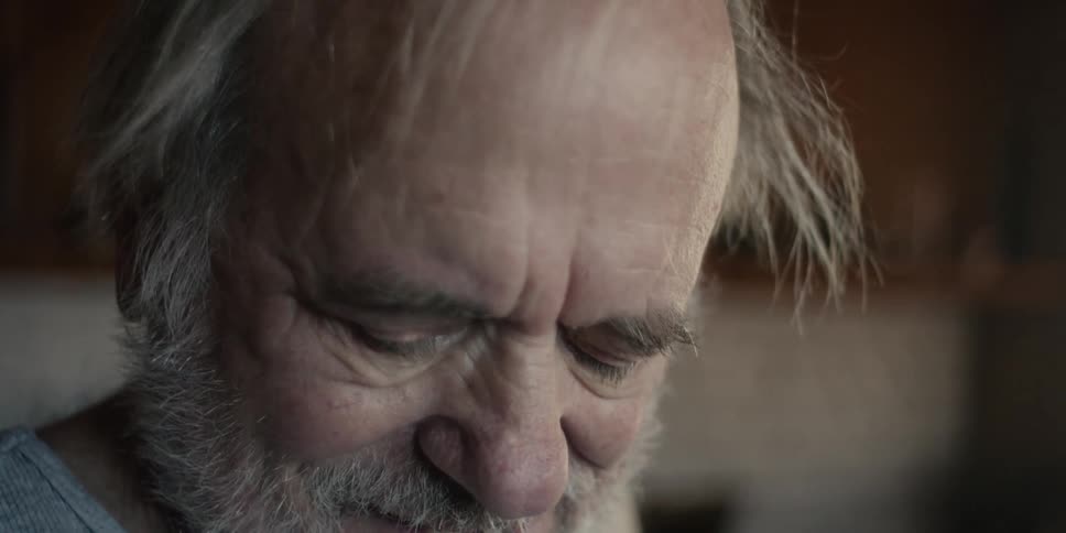 An elderly man turning his head to exercise his neck