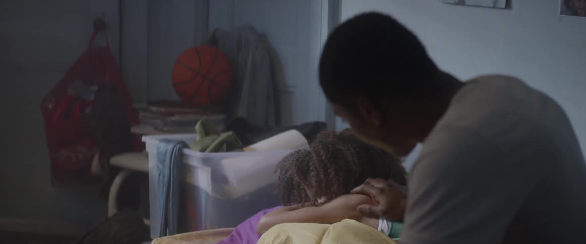A teenage boy wakes up a young girl