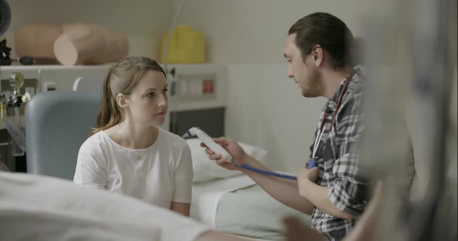 A woman gets her temperature taken