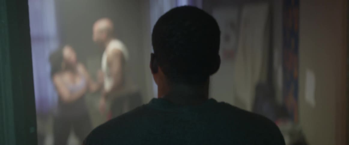 A teenager walks into a room where his parents are physically fighting