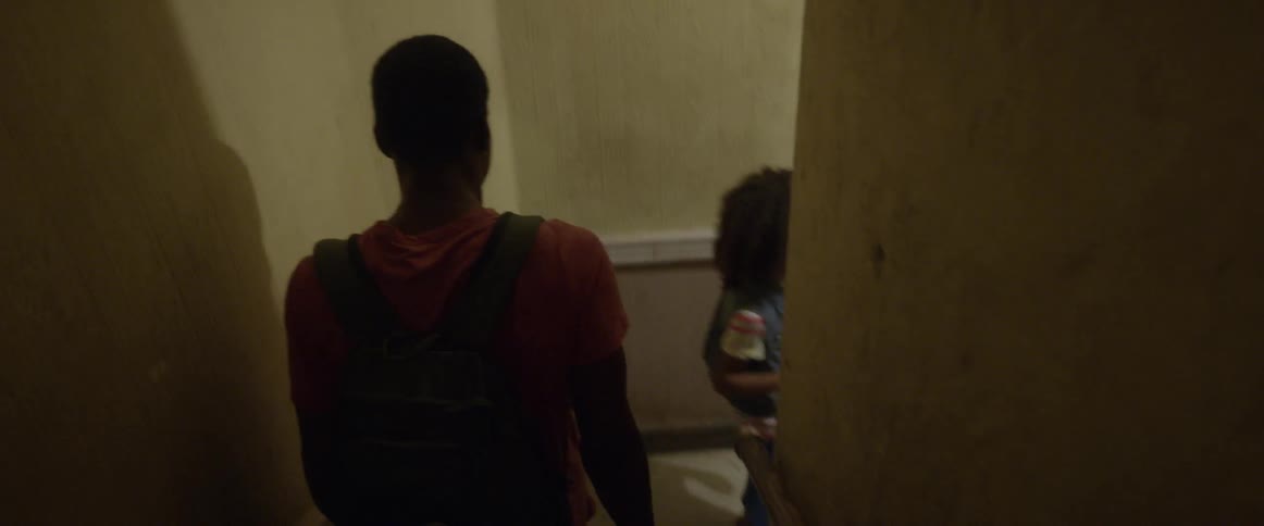 Two kids walk down an apartment staircase