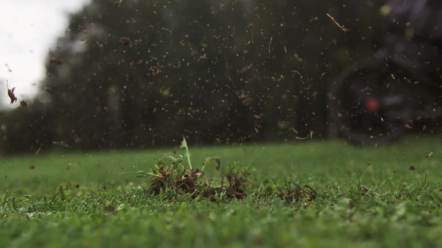 Club hitting a golf ball on a grass field