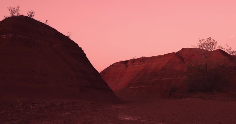 Landscape with desert reliefs against a reddish sky