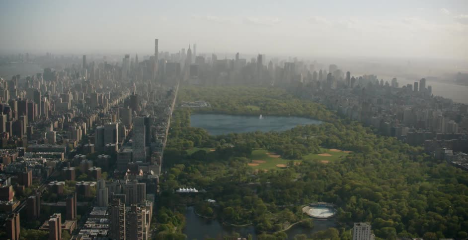 Central park stretches out amidst tall buildings on a hazy day