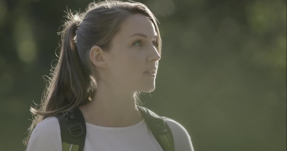 A woman is talking on a sunny day
