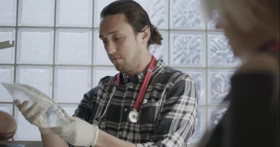 A doctor adjusts a bag of fluids