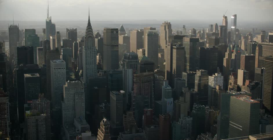 The sun shines on roof tops and city skyscrapers