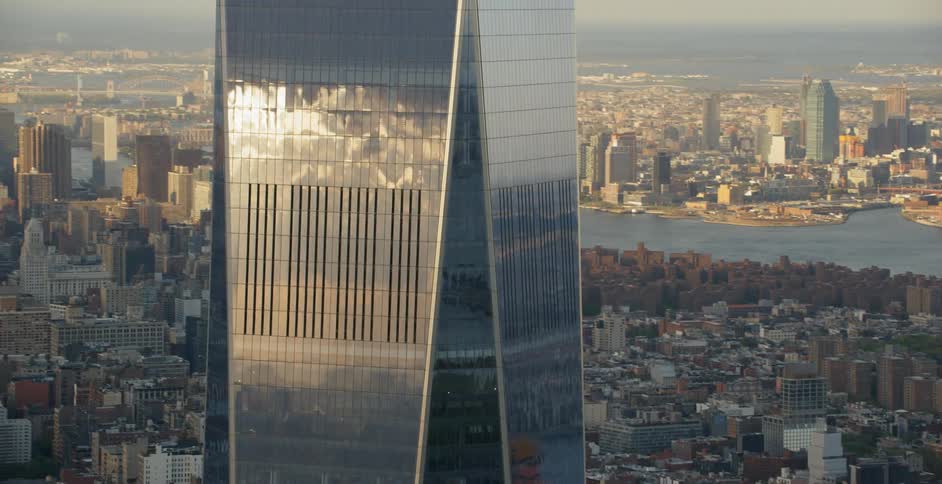 Skycraper towers above many other buildings by a river