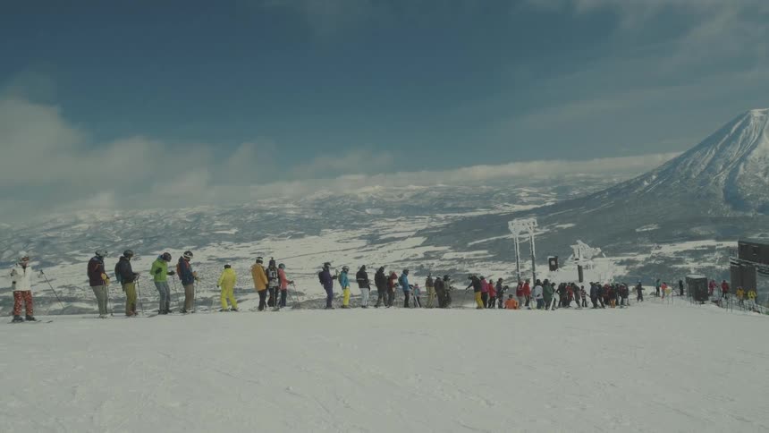 People are lined up on the slope