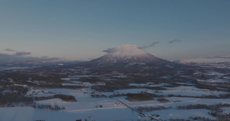 A large mountain is at the end of the landscape