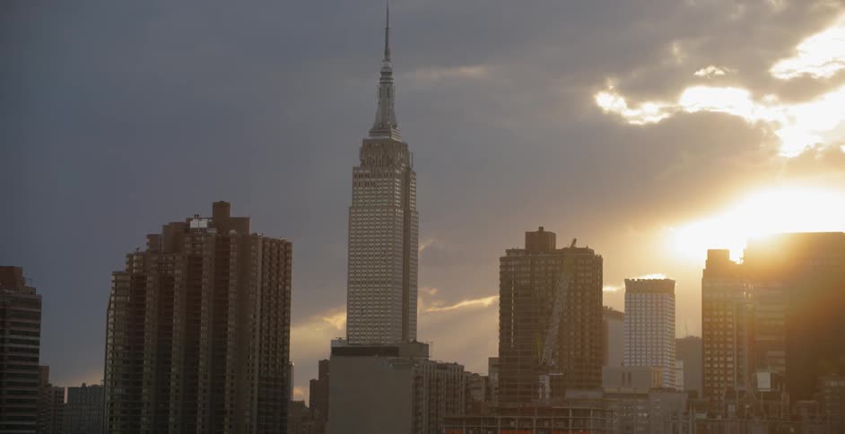 Clouds pass by a city skyline