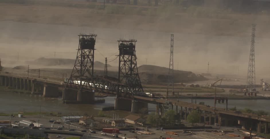 A train crosses a bridge on a foggy day