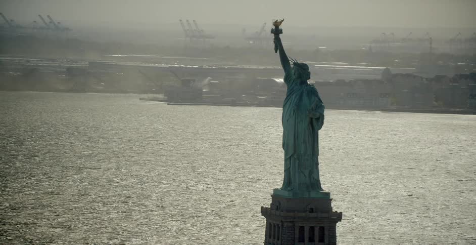 The statue of liberty towers above the water