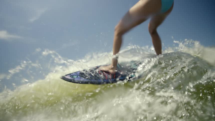 Woman surfing a wave with a surfboard