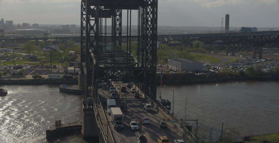 Cars drive over a city bridge