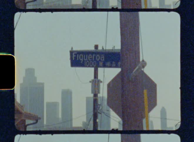Street sign for figueroa with 1000 w and chinese characters caught on vintage film