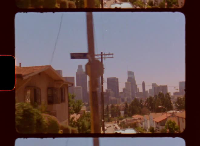 View of a residential neighborhood and skyscrapers of a metropolis in the background