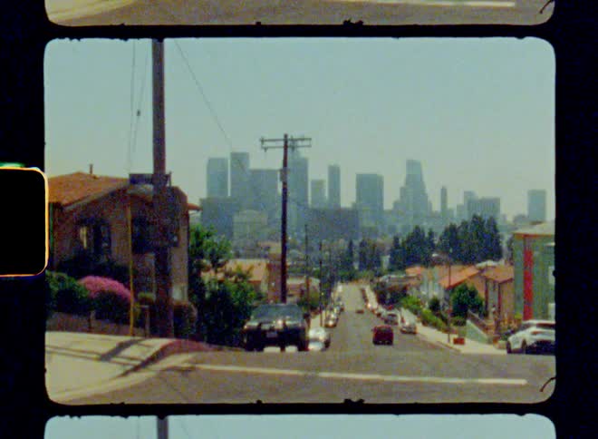 A car drives down the road towards the city