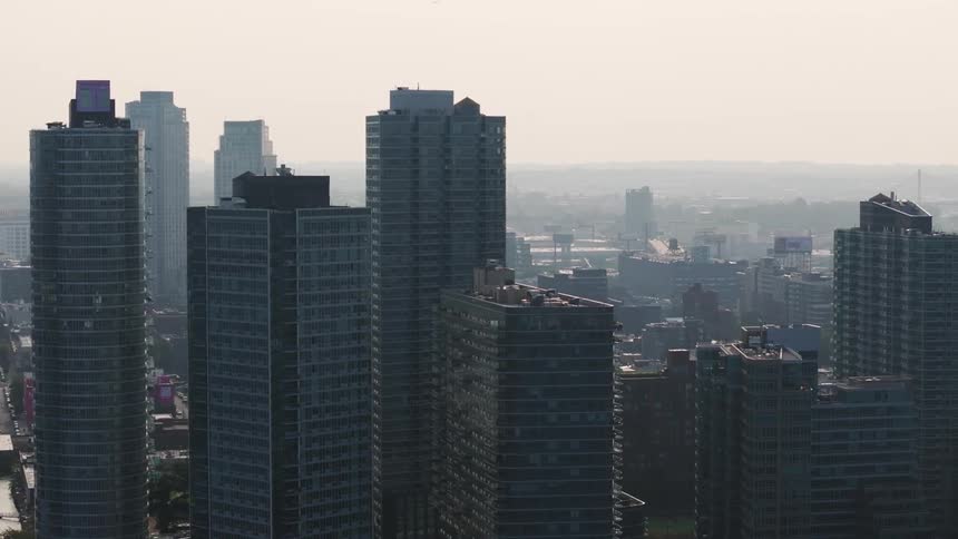 An aerial shot of a city skyline with numerous tall modern buildings