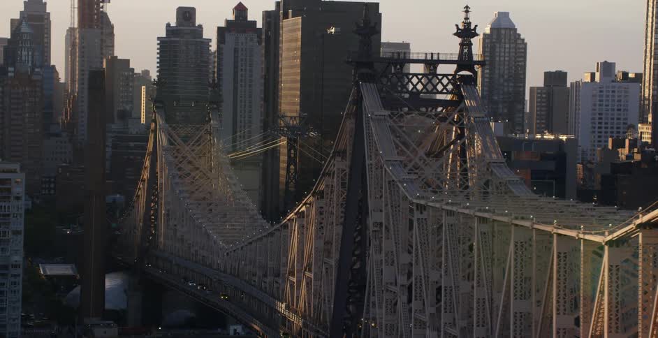 Aerial view of a large bridge leading into a large city