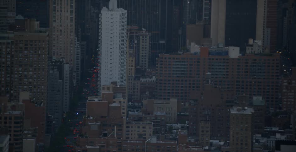 A city skyline with lots of traffic on the streets