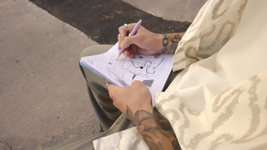 A man is drawing on a pad