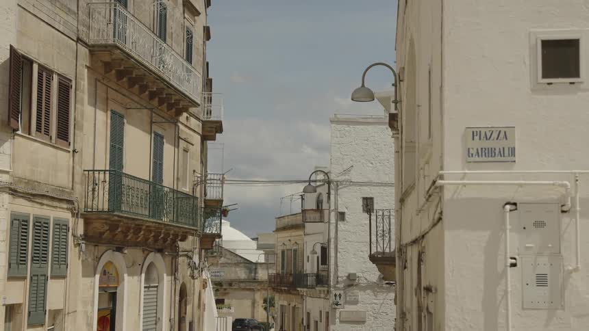 Street of a residential city with urban buildings and classical architecture in white