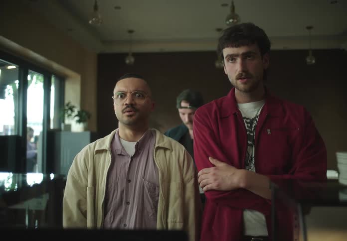 Two men in a line inside looking impressed
