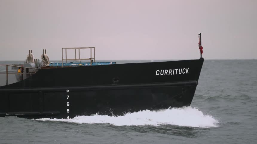 Cargo ship moving through the water on a clear day