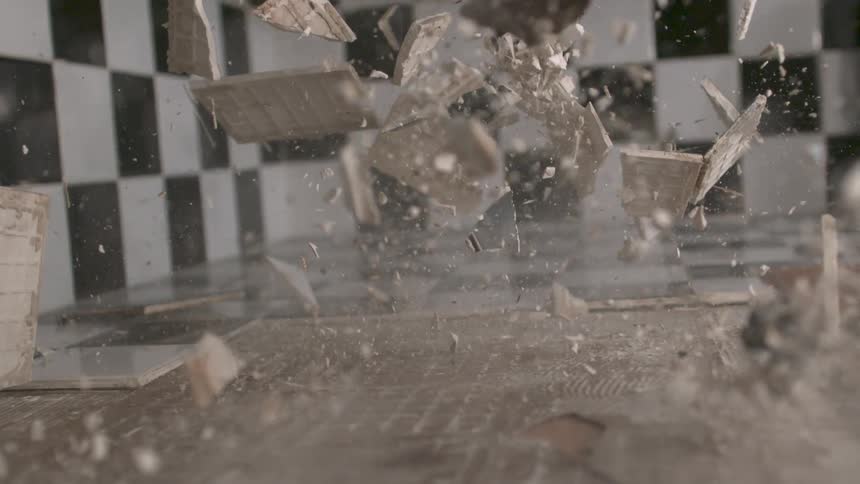 A sledgehammer hitting a countertop and shattering it