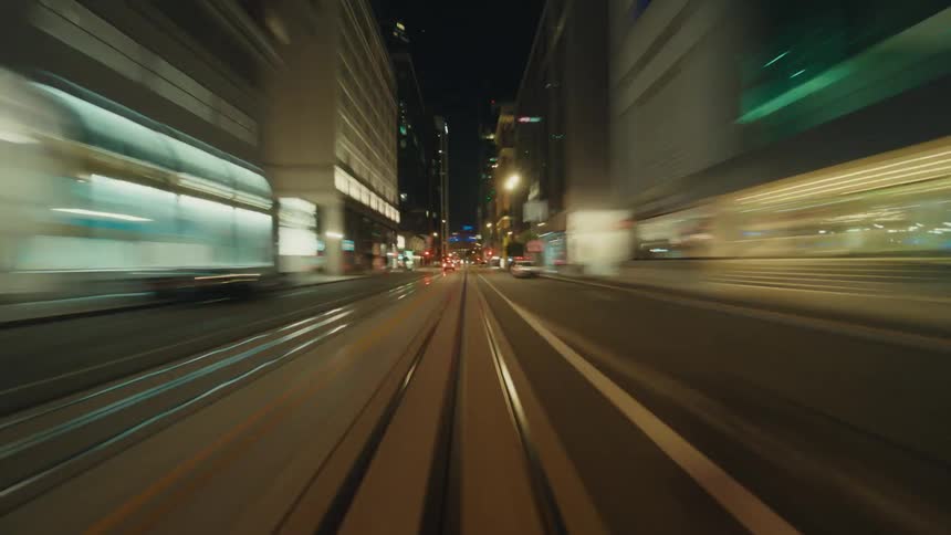 City lights illuminate nearly empty downtown streets at night