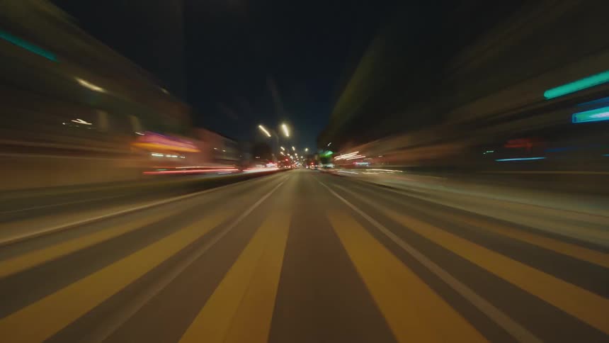 Moving and blurred view of streets of a metropolis at night