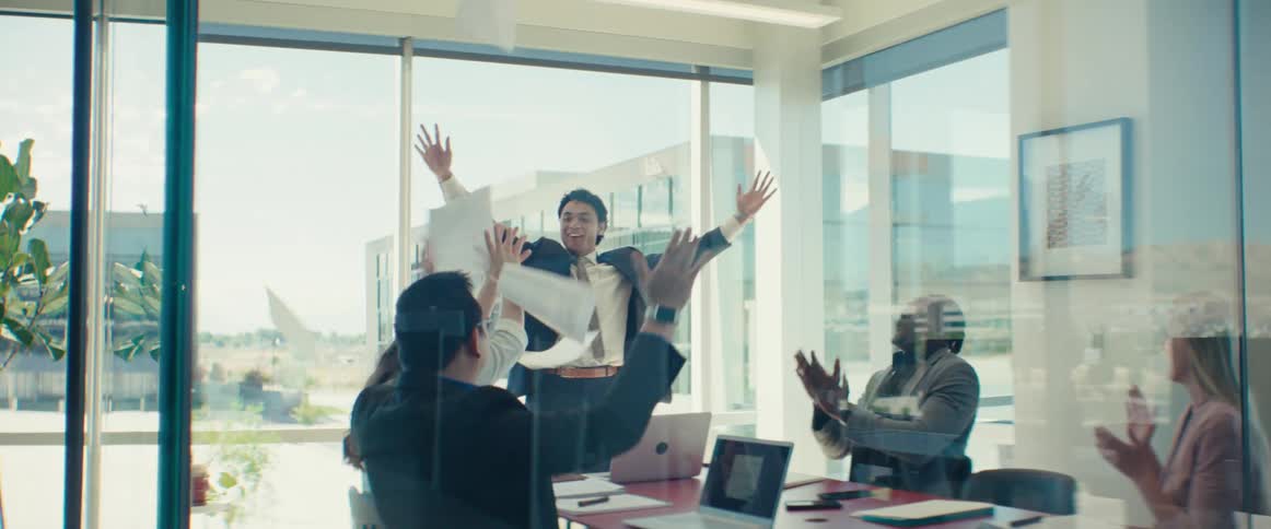 People in a meeting in an office celebrating