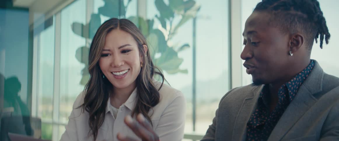 Man and woman sitting in an office environment talking