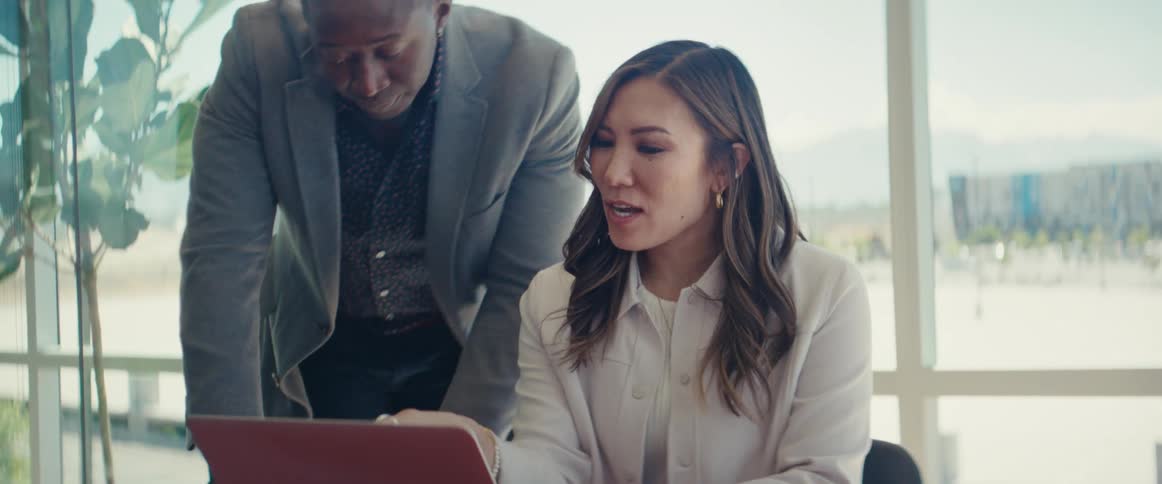 Woman and a man in an office environment talking