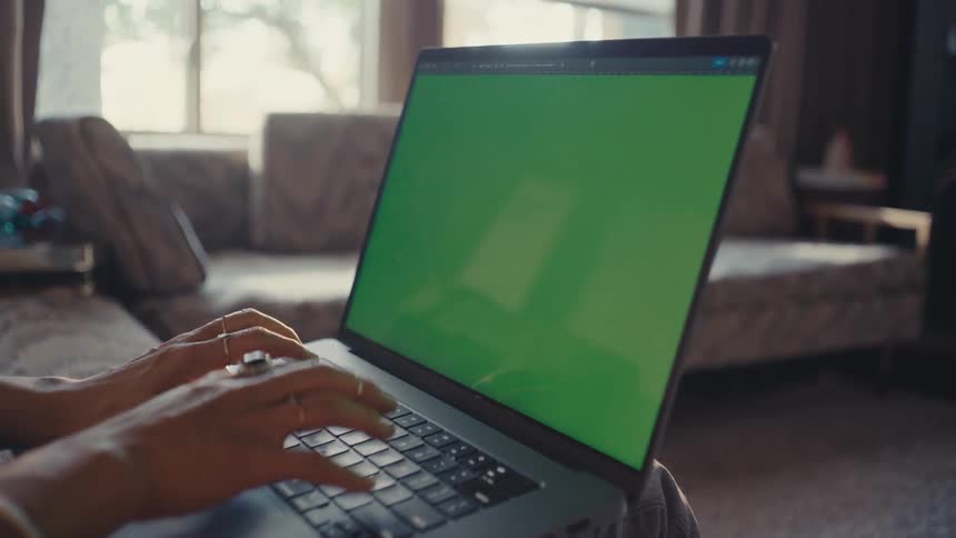 Hands of a woman typing on a laptop