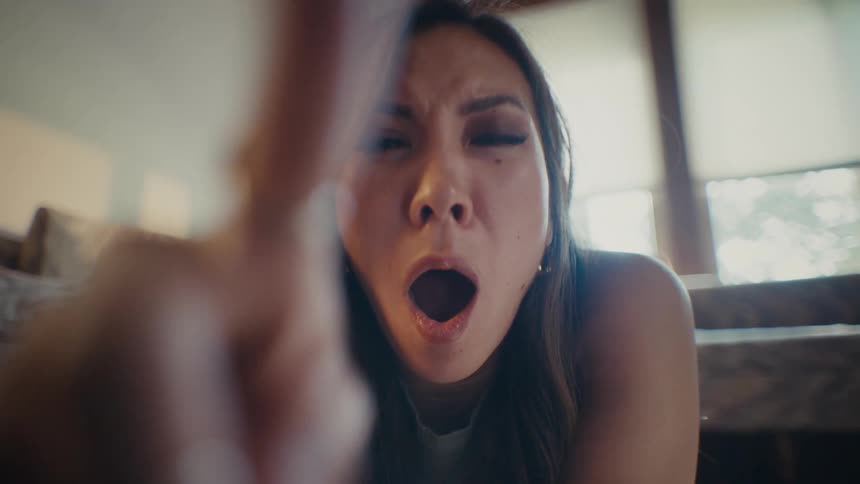 A woman flicks her fingers as she yawns