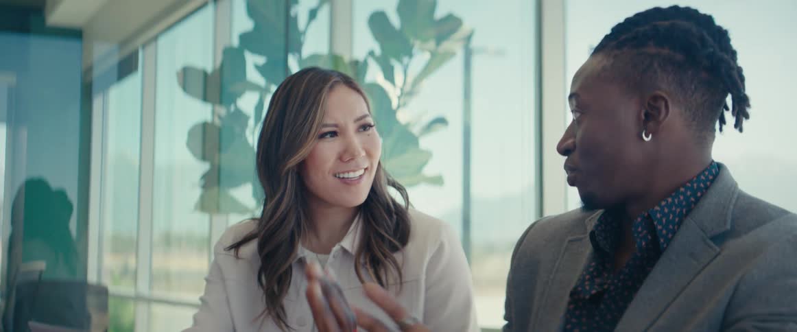 Two office workers have a conversation