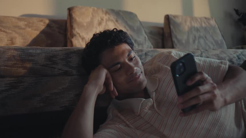 Man lying down using a smartphone