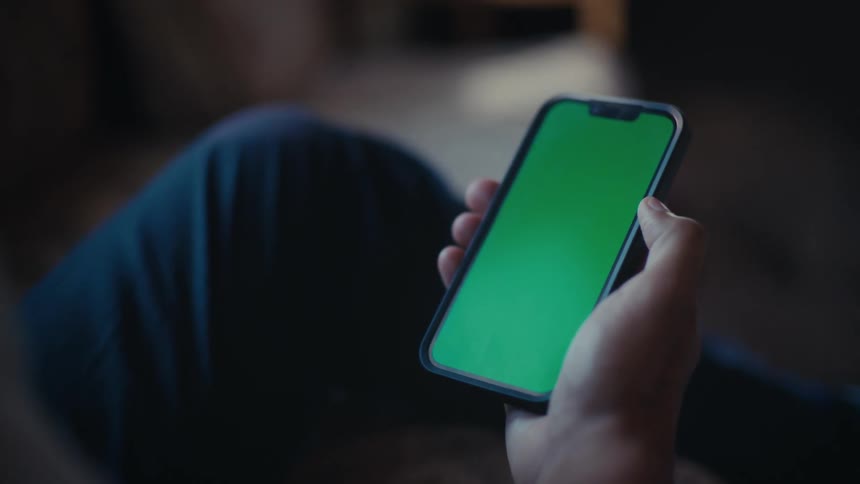 Hand picking up a smartphone and interacting