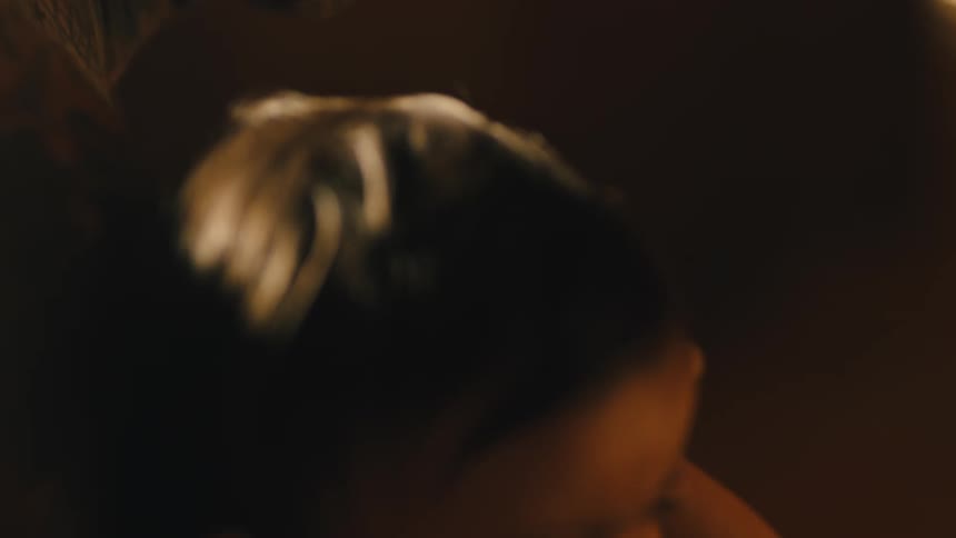 A gruff looking older man embraces a small child
