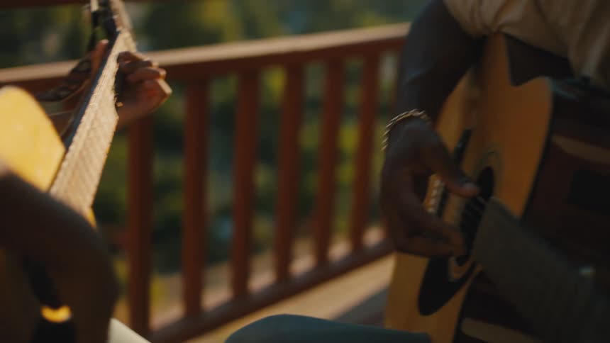 Man and a small boy playing guitar