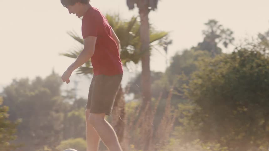 Two young men playing soccer on the ground
