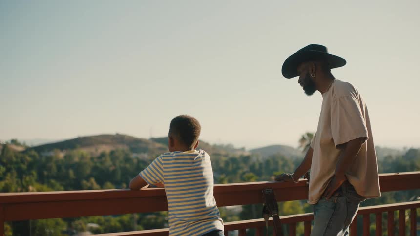 Man in hat next to a child