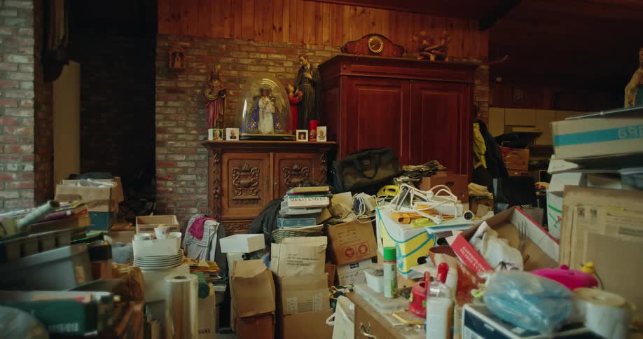 A cluttered room with boxes of household items and various objects