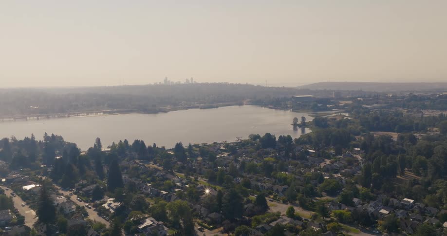 Traverse over the Laurelhurst neighborhood as brown smoke obscures Union Bay and the city skyline beyond