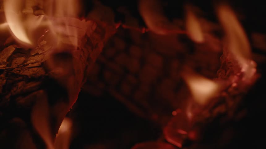 Close up of firewood burning in a dark room
