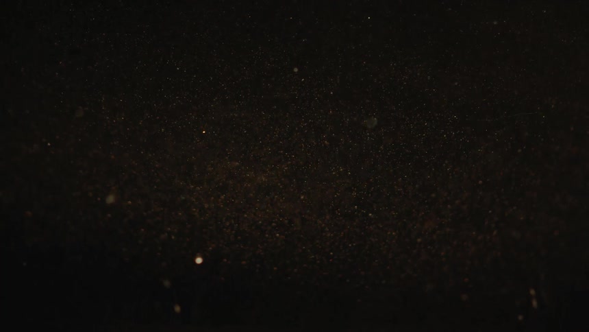 Abstract powder falling in a dark environment